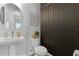 Chic powder room featuring pedestal sink, modern toilet, and decorative wood wall at 9250 Neher St, Orlando, FL 32827