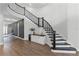 Elegant curved staircase with dark wood railing, landing with bar, and open floor plan at 9250 Neher St, Orlando, FL 32827