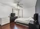 Serene bedroom with a ceiling fan, generous natural light, and classic hardwood floors at 940 Douglas Ave # 118, Altamonte Springs, FL 32714