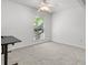 Bright bedroom features neutral carpet, a ceiling fan, and a window with natural light at 940 Douglas Ave # 118, Altamonte Springs, FL 32714