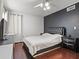 Comfortable bedroom with a ceiling fan, accent wall, and sleek hardwood flooring at 940 Douglas Ave # 118, Altamonte Springs, FL 32714