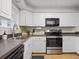 Efficient kitchen with white cabinets, neutral countertops and stainless steel appliances at 940 Douglas Ave # 118, Altamonte Springs, FL 32714