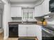 Functional kitchen with white cabinets, efficient appliances, and a streamlined layout at 940 Douglas Ave # 118, Altamonte Springs, FL 32714