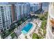 Aerial view of complex with pool, green spaces, palm trees and outdoor seating at 100 S Eola Dr # 1102, Orlando, FL 32801