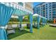 Inviting poolside cabana with striped awning, curtains, and lounge furniture at 100 S Eola Dr # 1102, Orlando, FL 32801