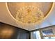 Close up of the massive and ornate chandelier, complete with crystal fixtures, mounted in the lobby at 100 S Eola Dr # 1102, Orlando, FL 32801
