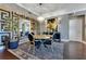 Stylish dining room complemented by sleek floors, modern lighting fixture and designer wall art at 100 S Eola Dr # 1102, Orlando, FL 32801