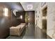 Hallway with elevator access, marble accent wall, wood paneling, mirror, and seating area at 100 S Eola Dr # 1102, Orlando, FL 32801