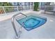 Rooftop hot tub features tiled trim, steel grab rail, and modern design at 100 S Eola Dr # 1102, Orlando, FL 32801