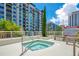 Condo hot tub boasts a tiled deck, modern railing, and city views at 100 S Eola Dr # 1102, Orlando, FL 32801