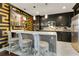 Modern kitchen featuring stainless appliances, quartz countertops, and unique accent wall and backsplash at 100 S Eola Dr # 1102, Orlando, FL 32801