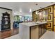 Bright kitchen with quartz countertop island and stainless steel dishwasher open to the home's main living area at 100 S Eola Dr # 1102, Orlando, FL 32801