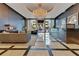Elegant lobby with a grand chandelier, seating areas, piano, and direct views of the building's entrance at 100 S Eola Dr # 1102, Orlando, FL 32801