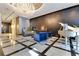 Beautiful condo lobby featuring a stunning chandelier, comfortable seating, and a grand piano at 100 S Eola Dr # 1102, Orlando, FL 32801