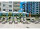 Poolside lounge area features cushioned lounge chairs and curtained cabanas at 100 S Eola Dr # 1102, Orlando, FL 32801