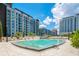 Modern community swimming pool has a shallow area and comfortable seating at 100 S Eola Dr # 1102, Orlando, FL 32801