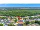 Aerial view of a single Gathering home with pool in a quiet residential neighborhood with wooded area nearby at 11209 Taeda Dr, Orlando, FL 32832