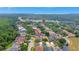 Scenic aerial view of a residential neighborhood with tree-lined streets and tranquil lake views at 11209 Taeda Dr, Orlando, FL 32832