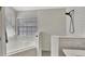 Modern bathroom features a glass-enclosed shower and separate soaking tub with a window at 11209 Taeda Dr, Orlando, FL 32832