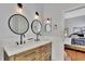 Elegant bathroom boasts double sinks, wood cabinets, quartz countertop, and trendy lighting at 11209 Taeda Dr, Orlando, FL 32832