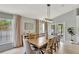 Inviting dining room featuring a long table, neutral paint, and modern light fixture at 11209 Taeda Dr, Orlando, FL 32832