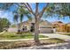 Inviting single-Gathering home with a lush lawn, mature trees, and a welcoming two-car garage at 11209 Taeda Dr, Orlando, FL 32832