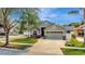 Desirable home boasts lush landscaping and charming architectural details, showcasing superb curb appeal at 11209 Taeda Dr, Orlando, FL 32832