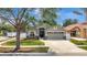 Beautifully landscaped home featuring a well-maintained lawn, stone accents, and an attached two-car garage at 11209 Taeda Dr, Orlando, FL 32832
