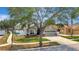 Charming single Gathering house featuring manicured lawn, mature tree, and welcoming curb appeal at 11209 Taeda Dr, Orlando, FL 32832