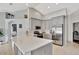 Bright kitchen featuring stainless steel appliances, light gray cabinets, and a spacious quartz countertop island at 11209 Taeda Dr, Orlando, FL 32832