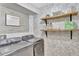 Well-organized laundry room with modern washer and dryer, shelving, and stylish wallpaper at 11209 Taeda Dr, Orlando, FL 32832
