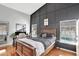 Spacious main bedroom featuring a dark accent wall and wood floors at 11209 Taeda Dr, Orlando, FL 32832