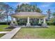 Community picnic pavilion featuring stone pillars, picnic tables and a lush green lawn at 11209 Taeda Dr, Orlando, FL 32832