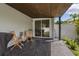 Covered patio with tiled floor, outdoor seating, and view to dining room through sliding glass doors at 116 Hurst Ct, Deland, FL 32724