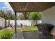 Back patio with a dark wood covering, an outdoor kitchen with grill, and chairs around a fire pit at 116 Hurst Ct, Deland, FL 32724