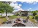 Backyard featuring a stone fire pit, four chairs, and easy access to the covered patio at 116 Hurst Ct, Deland, FL 32724