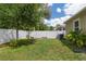 Fenced backyard with a healthy lawn, mature trees, and green landscaping at 116 Hurst Ct, Deland, FL 32724