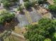 Aerial view of basketball courts, playground, walking path and lush trees creating an ideal recreational area at 116 Hurst Ct, Deland, FL 32724