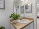 Bright bathroom featuring a vanity with sink, updated fixtures, and neutral color scheme at 116 Hurst Ct, Deland, FL 32724