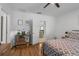 Comfortable bedroom with wood flooring, natural light, and a view into the kitchen at 116 Hurst Ct, Deland, FL 32724