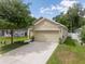 Charming home featuring a spacious driveway, two-car garage, and well-maintained landscaping at 116 Hurst Ct, Deland, FL 32724