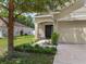 Well-maintained front yard featuring a charming home, lush landscaping, and a welcoming entrance at 116 Hurst Ct, Deland, FL 32724