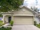 Charming home featuring a two-car garage, manicured landscaping, and classic architectural details at 116 Hurst Ct, Deland, FL 32724
