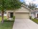 Charming single-Gathering home with a well-manicured lawn, mature trees, and an attached two-car garage at 116 Hurst Ct, Deland, FL 32724