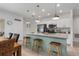 Bright eat-in kitchen features granite countertops, stainless steel appliances, and a stylish breakfast bar at 116 Hurst Ct, Deland, FL 32724