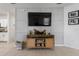 Living room featuring a modern console beneath a large television and stylish wall decor at 116 Hurst Ct, Deland, FL 32724