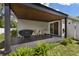 Covered patio with tile flooring, grill, and access to the interior via sliding glass doors at 116 Hurst Ct, Deland, FL 32724