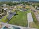 Aerial view of a well-maintained baseball field with seating, press box, and meticulously manicured green grass at 116 Hurst Ct, Deland, FL 32724