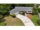 Aerial view of home with manicured lawn, and a long, paved driveway at 1209 Stevens Ave, Orlando, FL 32806