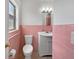 Cozy bathroom with pink tiling, a window, and a sink with vanity at 1209 Stevens Ave, Orlando, FL 32806